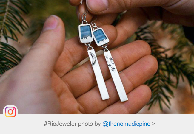 two silver earrings with blue stones